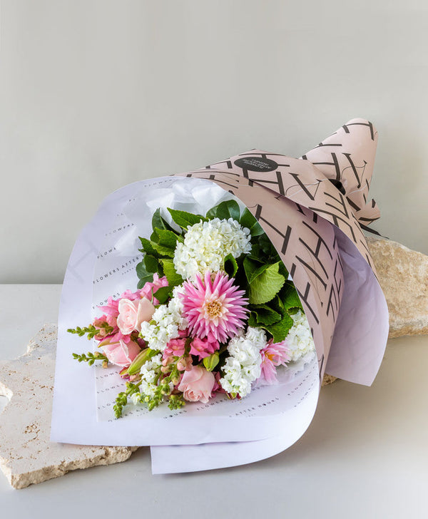 Elegant pink and white flower bouquet in decorative wrapping